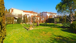 A residential area with houses, a grassy yard, and a garden.