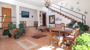 A spacious living area with a dining table, chairs, and a staircase leading to an upper floor. - Apartment 1571/16068 (Istria - Pula), 1500m from the beach (Pula)