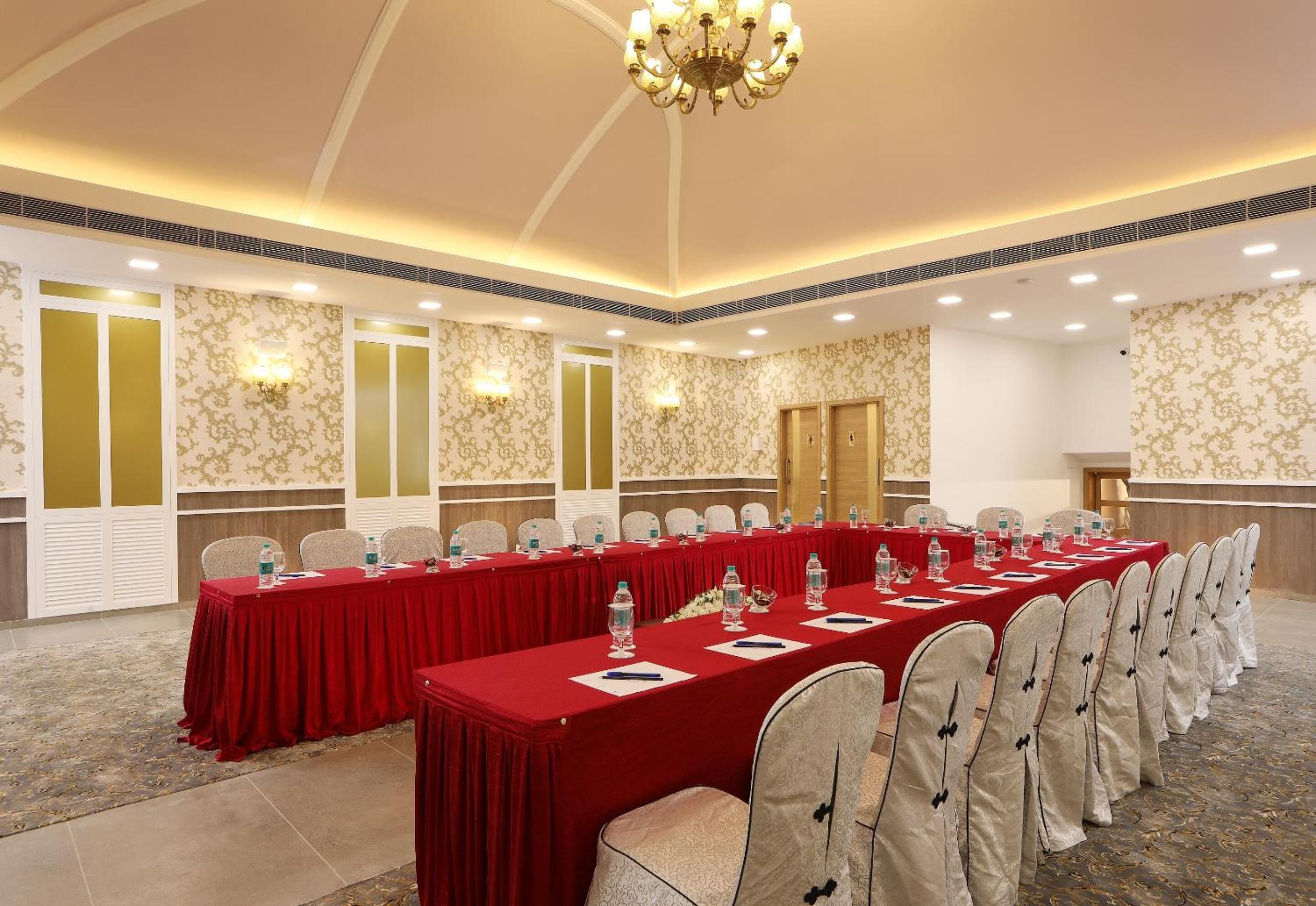 A conference room with a long table, chairs, and a chandelier.