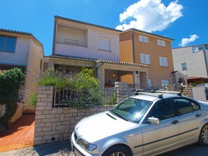 Stylish two-story residence with a covered entrance and upper-floor balcony.