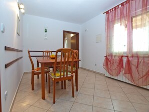 Enjoy meals in this cozy dining area with a wooden table and chairs.
