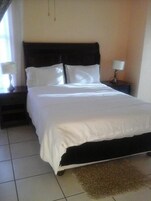 Escritorio, cortinas blackout y tabla de planchar con plancha