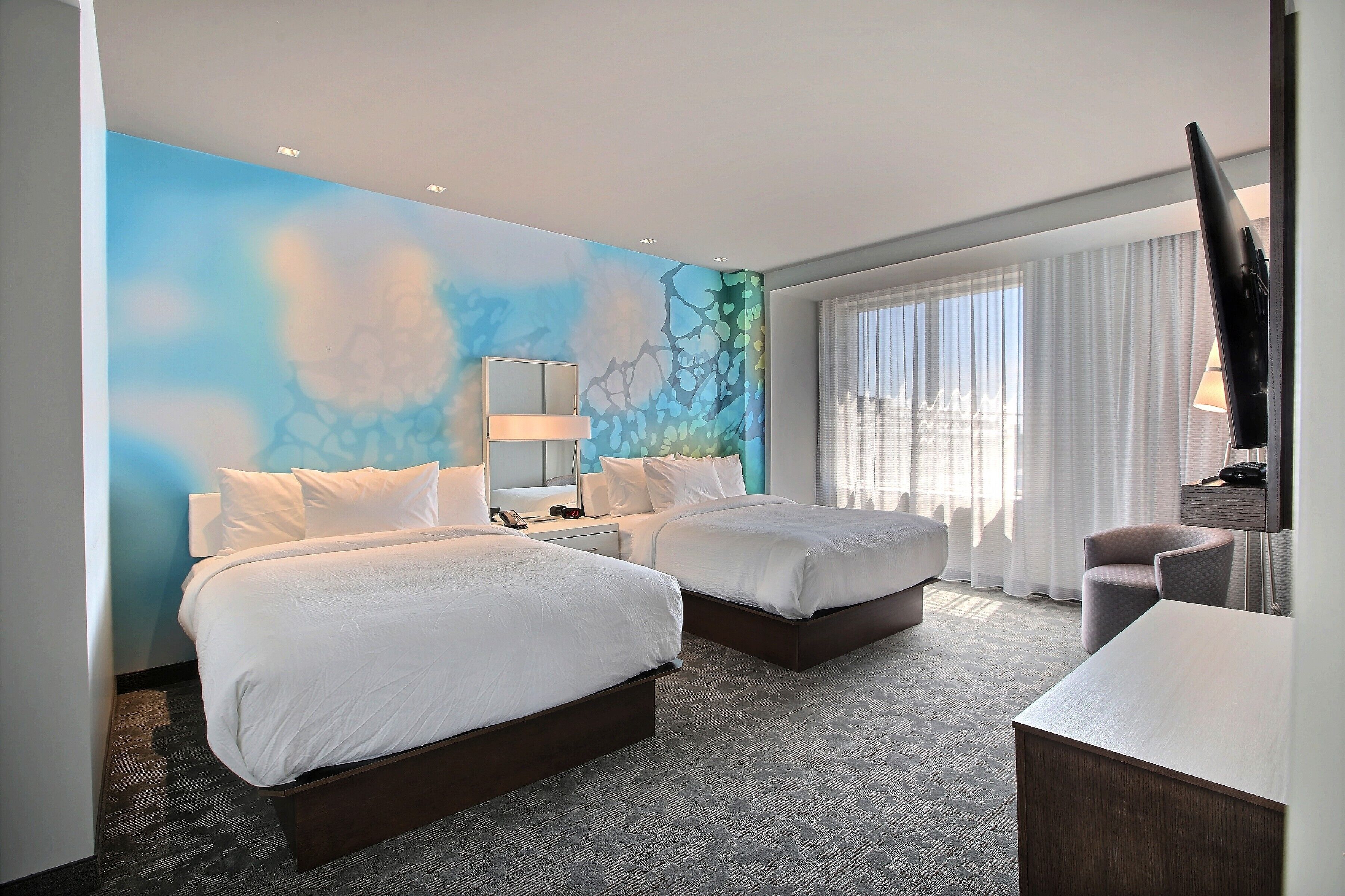 hypo-allergenic bedding, desk, laptop workspace, blackout curtains