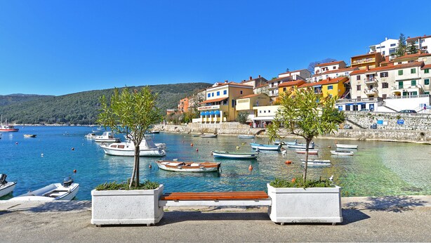 A coastal town with boats docked at a marina, colorful buildings, and a clear blue sky. - Apartment 1825/21668 (Istria - Rabac), 100m from the beach (Rabac)