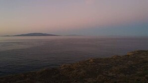 Un paisaje costero con vista al mar y tierra a lo lejos.
