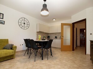 Cozy living space with a dining area, sofa, and kitchen.