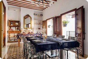 Enjoy meals in this dining area with a long table and comfortable seating for all.