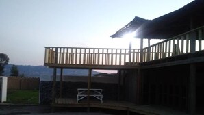 A two-story building with a balcony and a covered outdoor area. - Lawu Le Ngwenya Guest House (Motshane)