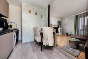 Enjoy a compact yet functional stay with a kitchenette, dining area, and living space.