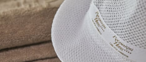 A white hat with a label that reads "Hotel Rocamarina".