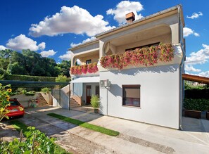 A two-story house with a balcony, a staircase, and a red car parked in the driveway. - Apartment 1965/25900 (Istria - Pula), 3250m from the beach (Pula)