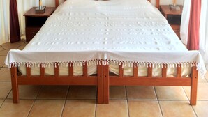 A bed with a canopy, wooden headboard, and two bedside tables with lamps. - Fox Apartments (Konavle)
