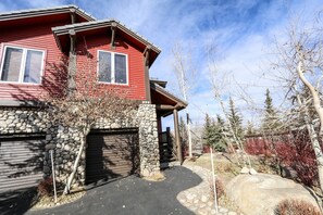 Stroll up the stone pathway to a two-story home with a deck and scenic views.