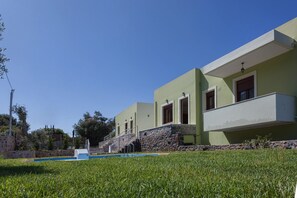 A modern building with a pool, stone steps, and a clear blue sky. - Mela Villas (Rethymno)