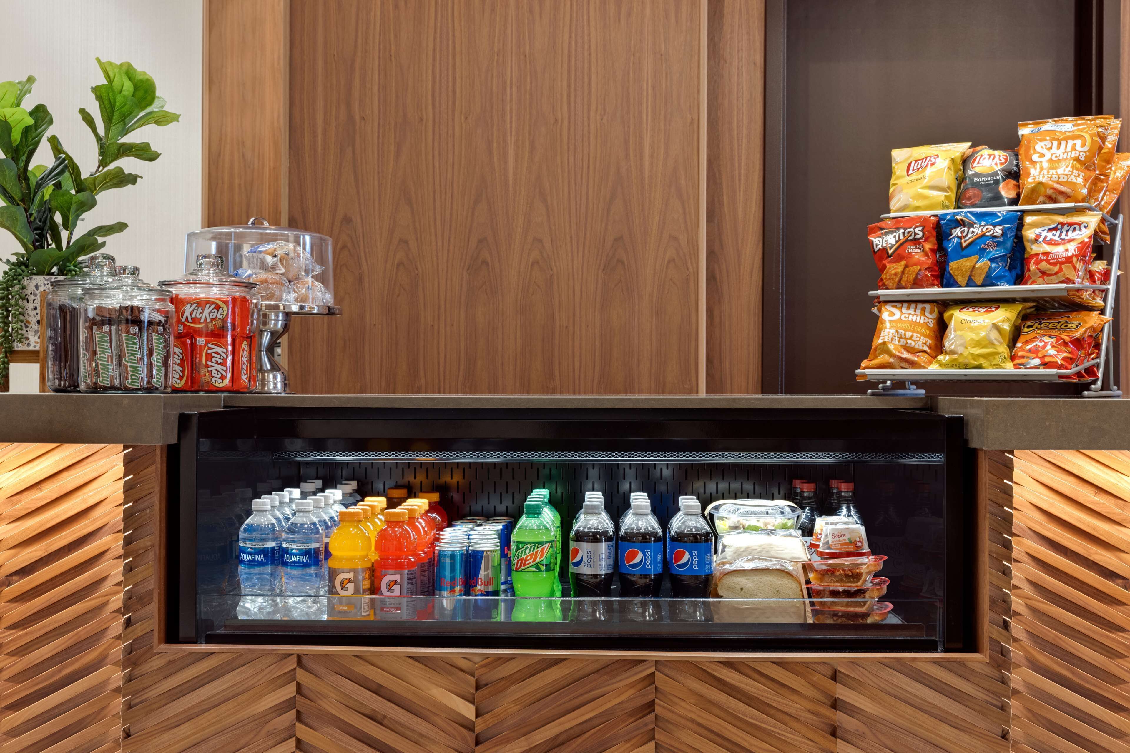 A snack and beverage display with various brands and types of snacks and drinks.