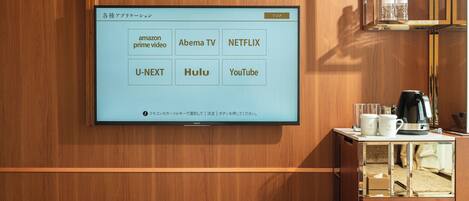 A wall-mounted TV displaying streaming services.