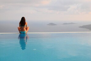 An infinity pool, pool loungers