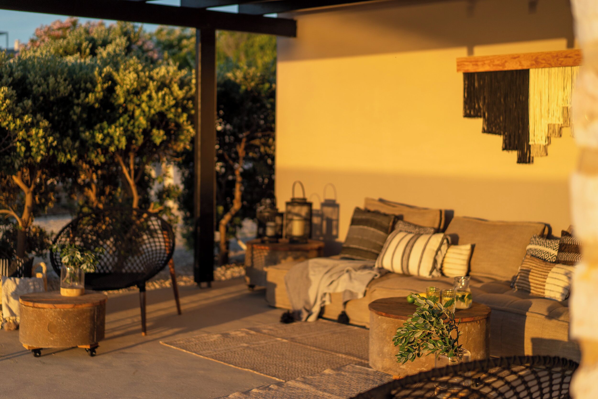 An outdoor seating area with a sofa, chairs, and a coffee table.