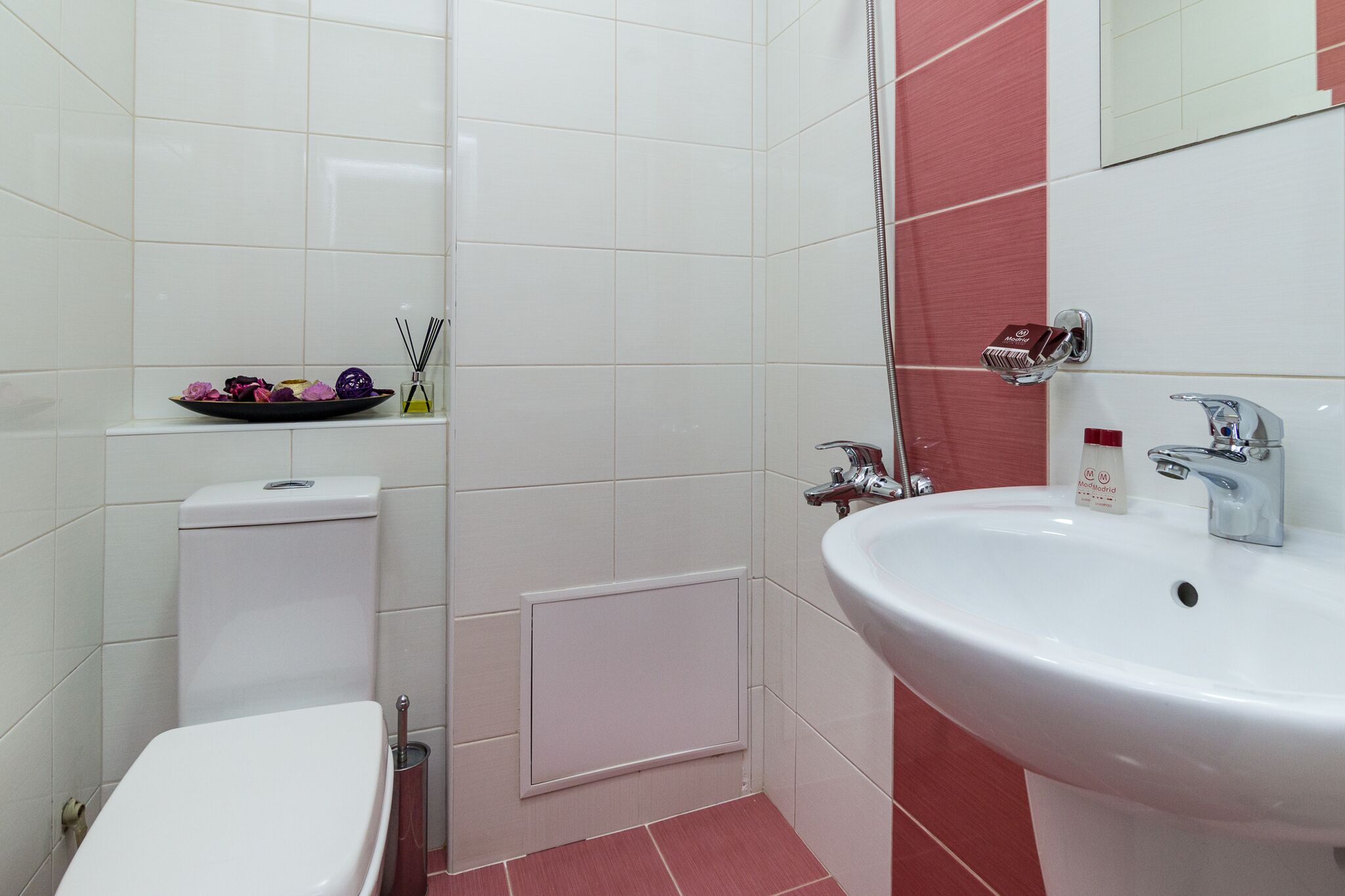 A bathroom with a toilet, sink, and shower.