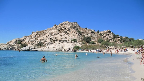 A beach with clear water, rocky hills, and people swimming and sunbathing. - Nikoletta's Nest / House with large veranda  (4kms from Agia Anna,Plaka+Chora) (Naxos)