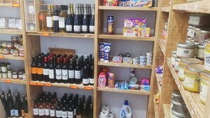 A store with shelves stocked with various products including wine bottles, canned goods, and household items. - Auberge des Isards (Aydius)