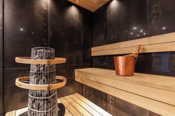 Premium appartement | Badkamer | Een douche, een regendouche, een haardroger, handdoeken