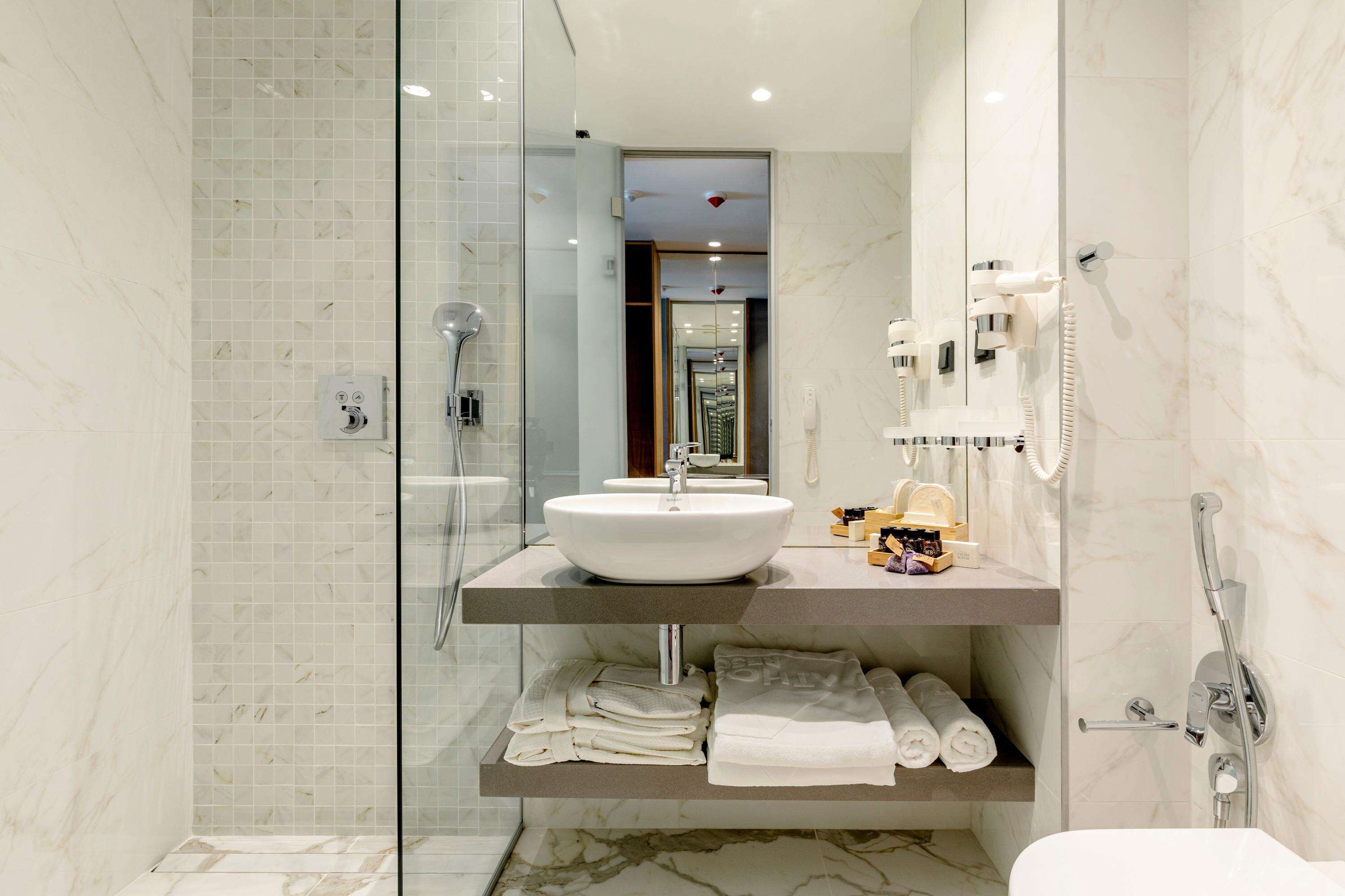 designer toiletries, hair dryer, bathrobes, slippers