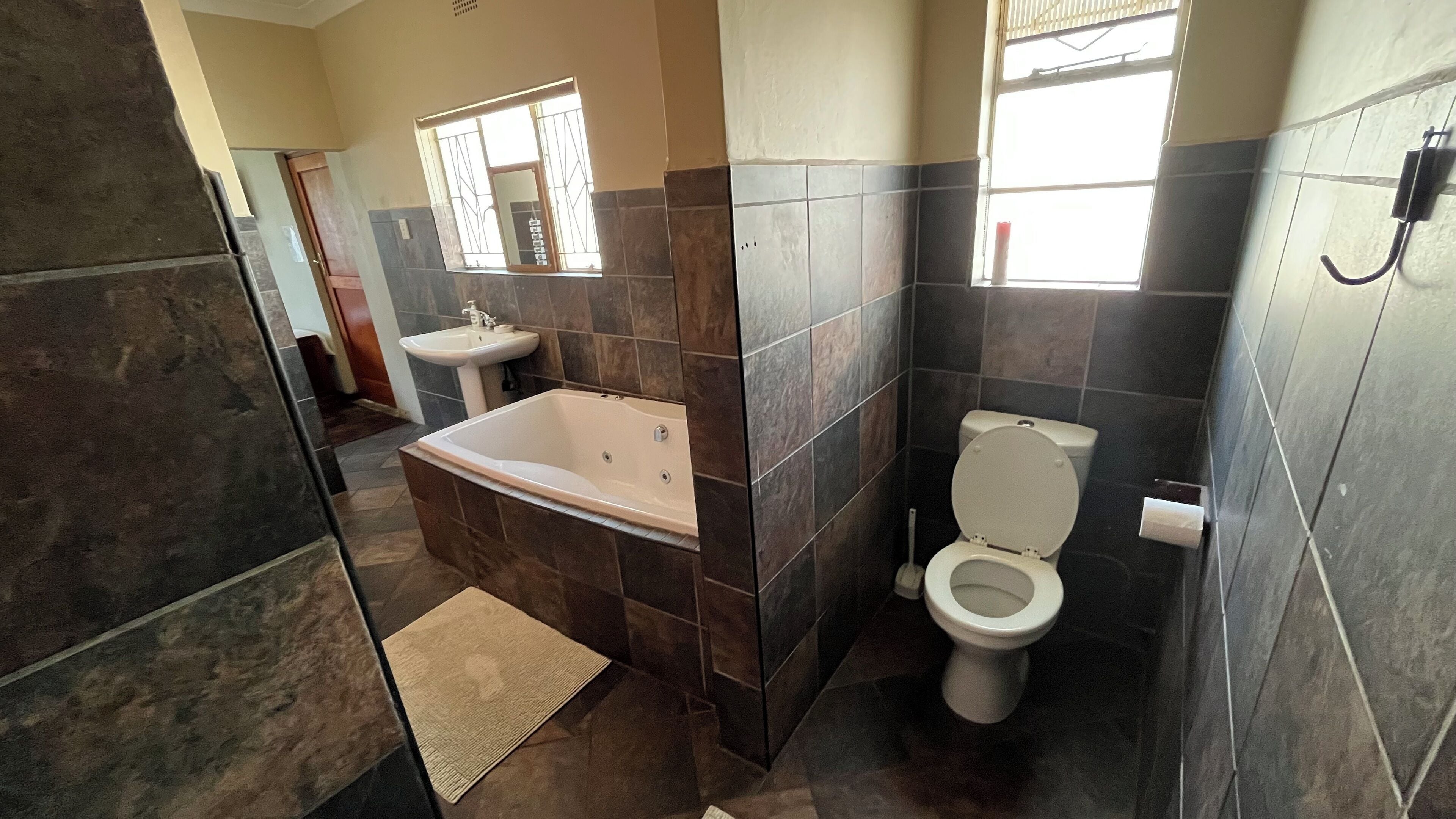 A bathroom with a bathtub, sink, and toilet.
