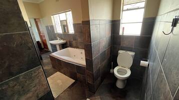 A bathroom with a bathtub, sink, and toilet.