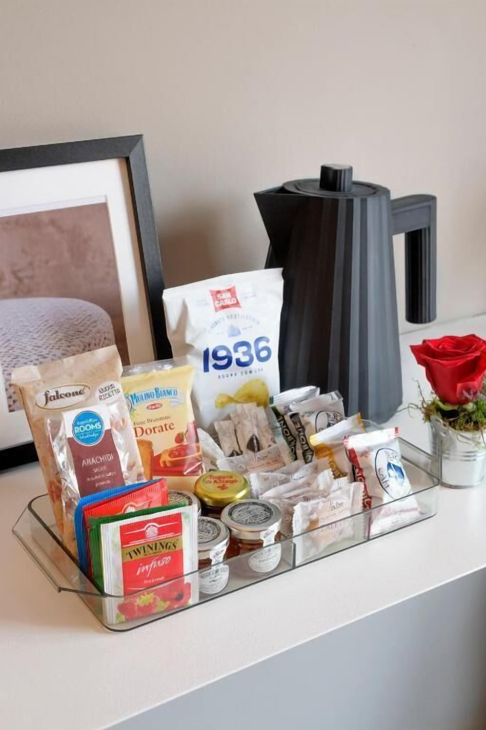 A kitchen counter with various food items and kitchenware.