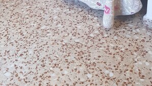 A room with two beds, each with a floral bedspread, a wooden headboard, and a bedside lamp. The floor is covered with a speckled tile pattern. - Hotel Andalucia (Cazorla)