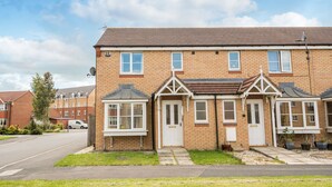 A two-story residential building with a symmetrical facade, a central entrance, and a small front garden. - Hillbrook (Stockton-on-Tees)