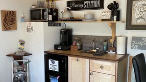 A compact kitchen with a coffee station, a refrigerator, and a microwave. - Cedar Twig Cabin: Serene and cozy (Mt. Juliet)