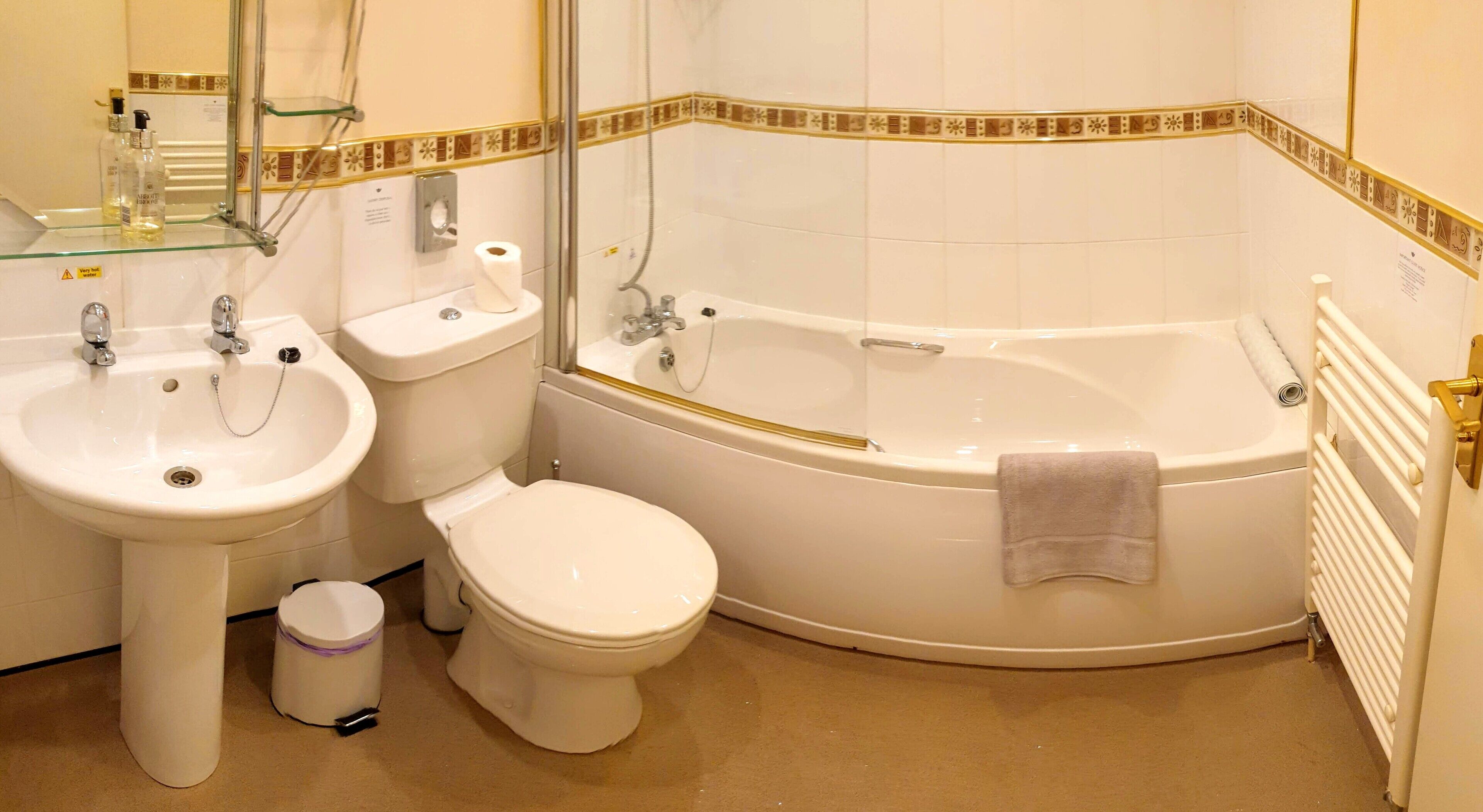 A bathroom with a sink, toilet, and bathtub.