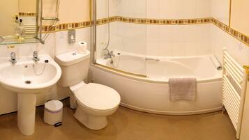 A bathroom with a sink, toilet, and bathtub.