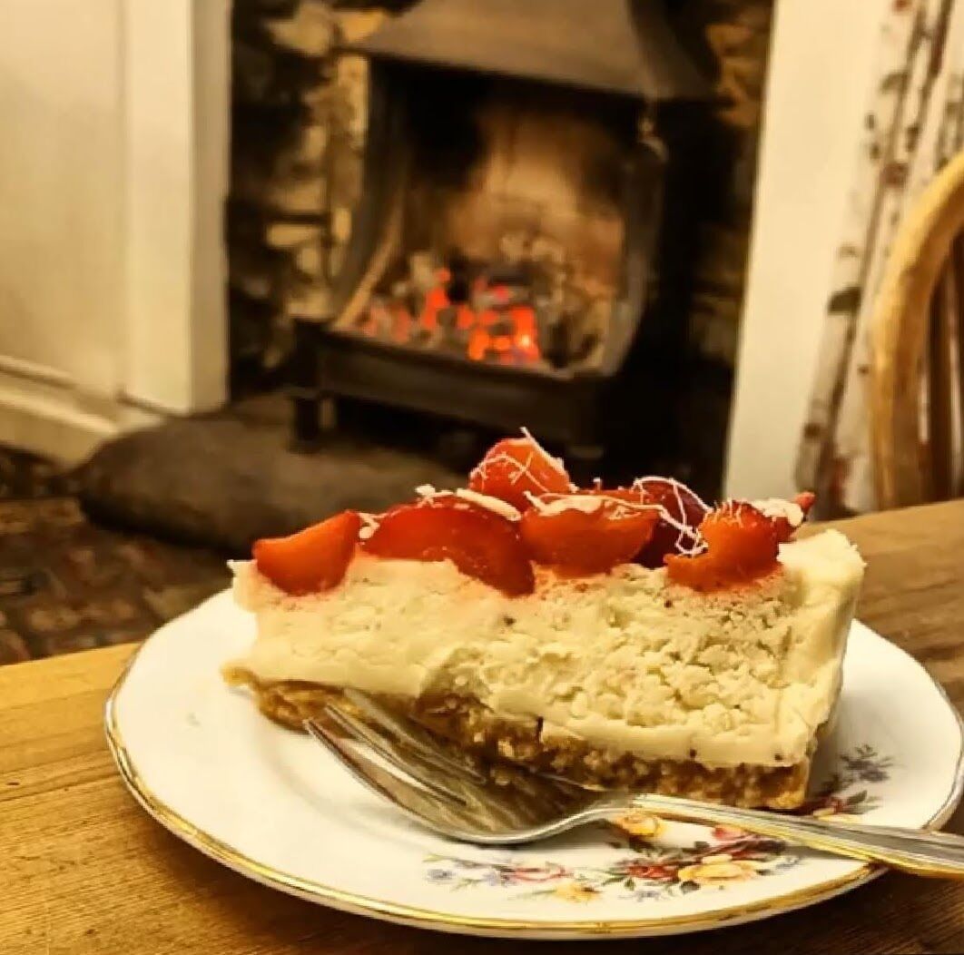 A slice of cheesecake with strawberries on a plate.