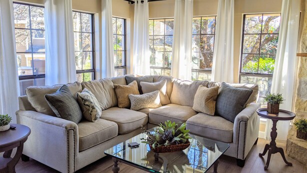 A living room with a sectional sofa, a glass coffee table, and a small side table. - 🌟LOCATION! Very Nice 2 BD 2BA Directly Across From Resort-Pool Grill Sleeps 6🏊 (Horseshoe Bay)