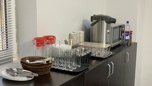 A kitchen counter with various glassware, plates, and utensils. - Hostel Paradise inn (Tashkent)
