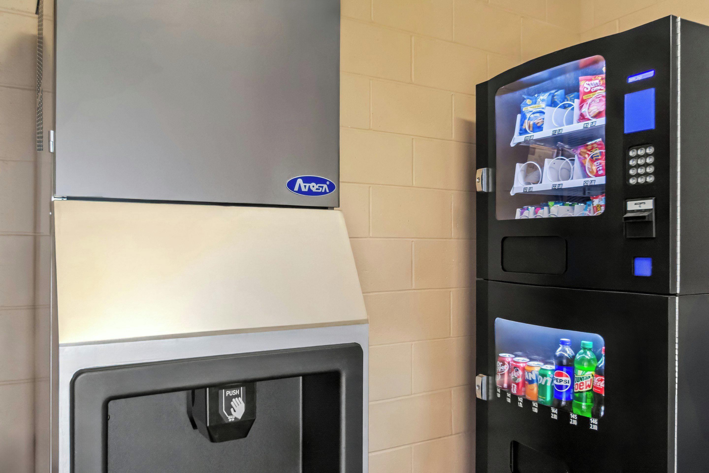A vending machine with a selection of beverages and snacks, a push button, and a digital display.