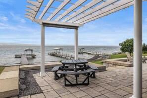 A waterfront park with a pergola, picnic tables, and a dock extending into the water. - Gracie's Place: Stunning Lakefront Escape on Seneca Lake! (Romulus)