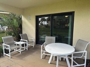 Guests can dine or socialize around the patio table and chairs.