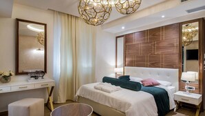 A modern hotel room with a large bed, a desk, and a vanity. - Miraval Luxury Rooms (Split)