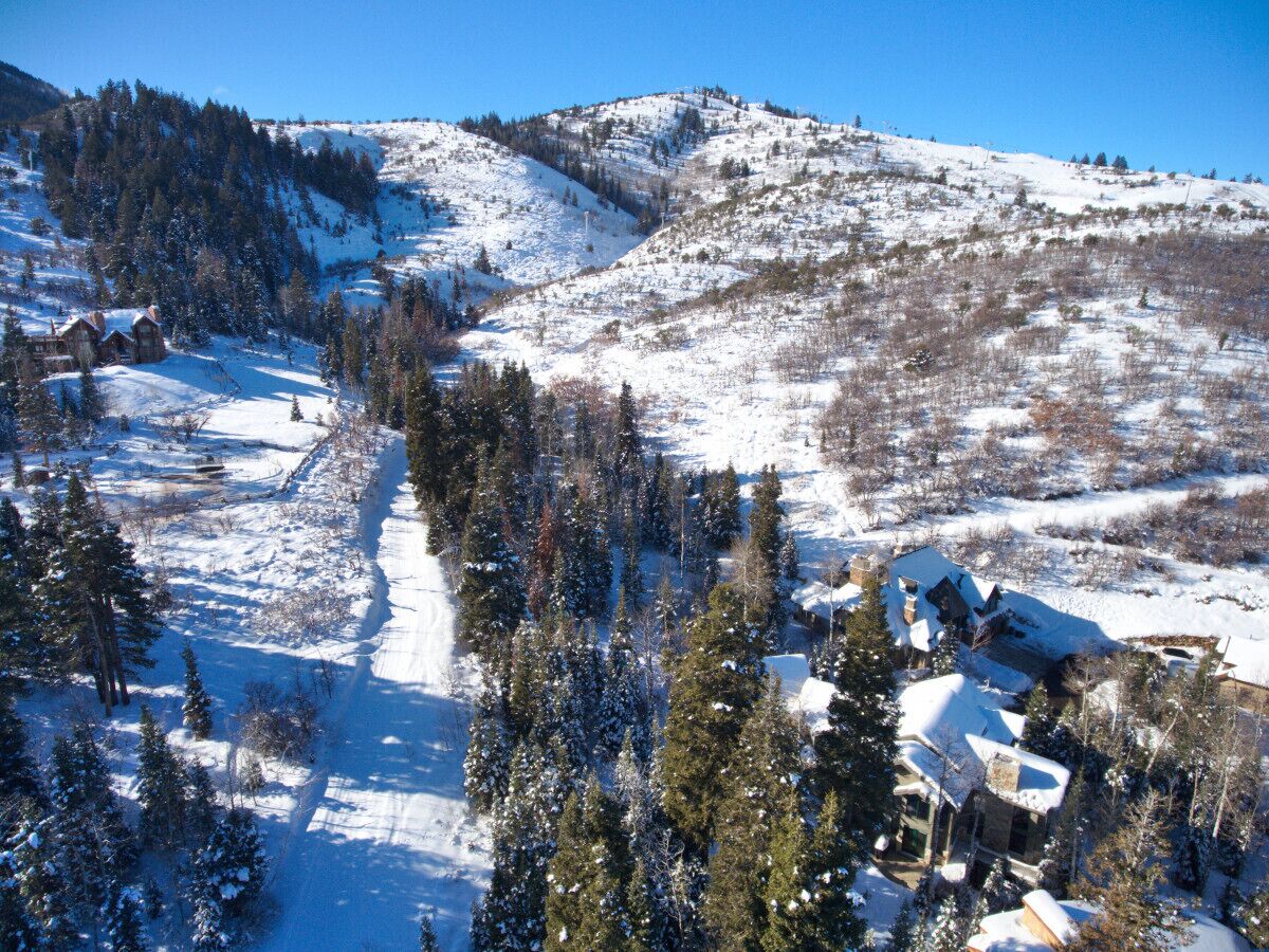 Un paysage montagneux enneigé avec une station de ski et des chalets.