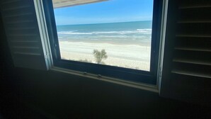 A window with a view of a beach. - Oceanfront 2 Bedroom Townhouse Summerhouse 305 (ST. AUGUSTINE)