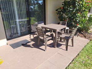 Enjoy al fresco dining on the patio with a garden view.
