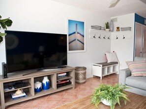Relax in this inviting space with a flat-screen TV, comfortable sofa, and cozy reading nook.