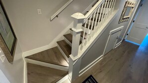 A staircase with white railings and wooden steps.