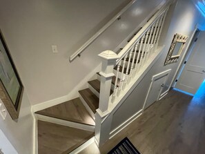 A staircase with white railings and wooden steps.