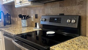 A kitchen with a stainless steel refrigerator, microwave, and oven. - Beautiful Direct Oceanfront 2 bed 2.5 bath Townhouse- Summerhouse 162 (St. Augustine)
