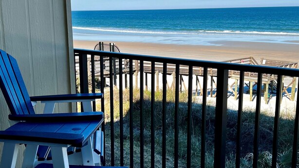 A balcony with blue chairs and a view of the beach. - Beautiful Direct Oceanfront 2 bed 2.5 bath Townhouse- Summerhouse 162 (St. Augustine)